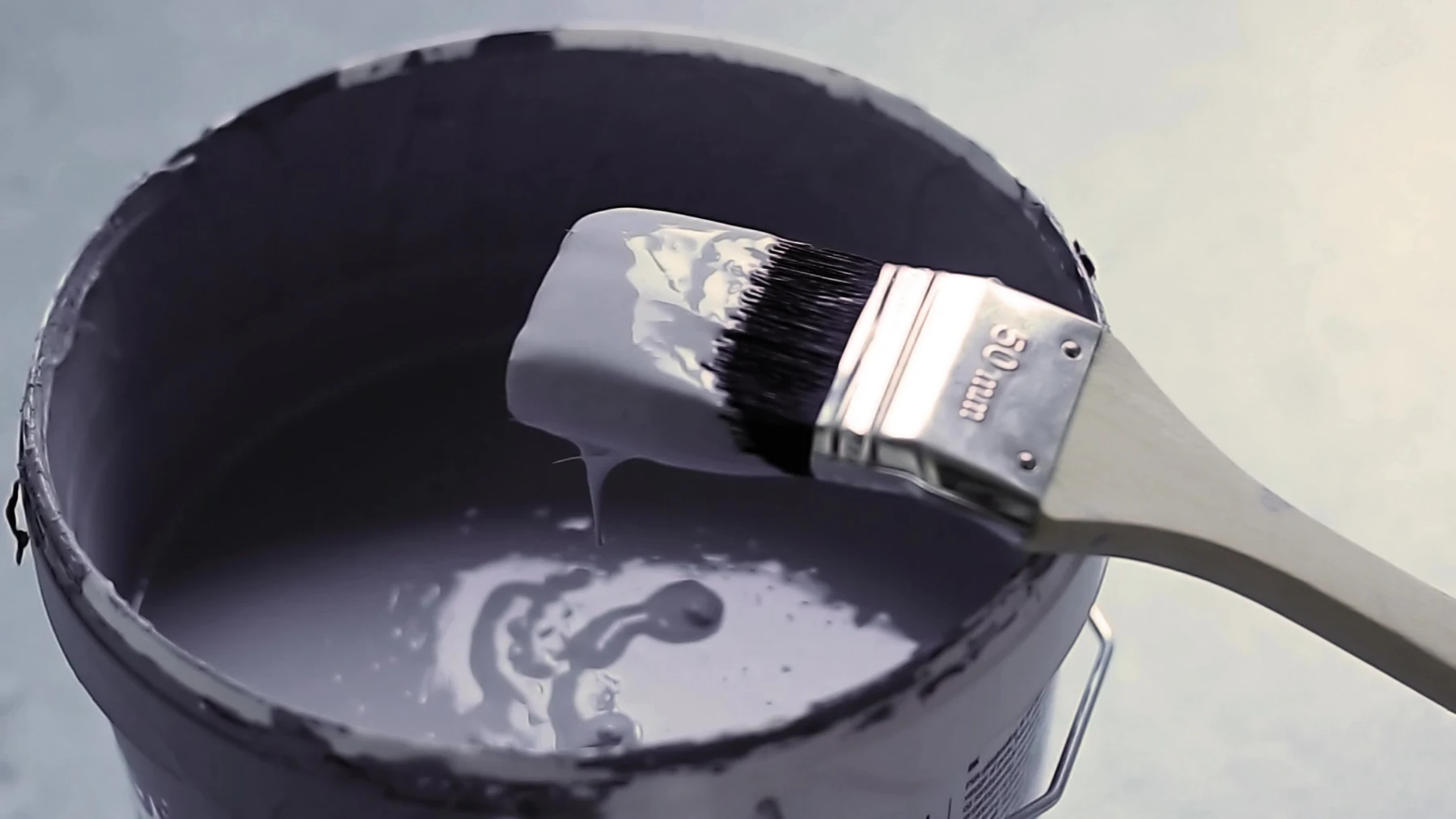 Pinceau posé sur un pot de peinture en cours de préparation